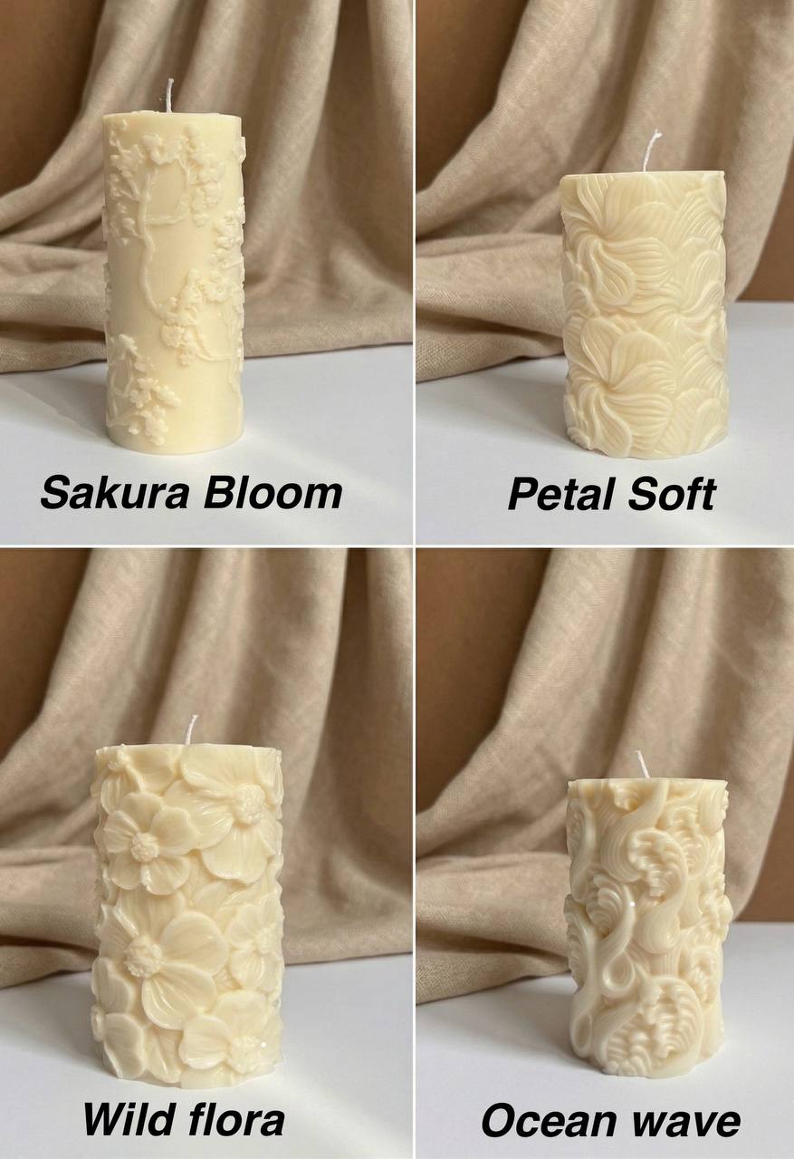 Four cream-colored textured pillar candles arranged in a 2x2 grid with draped beige fabric in the background. Each candle has a different name printed below it: Sakura Bloom, Petal Soft, Wild flora, and Ocean wave.