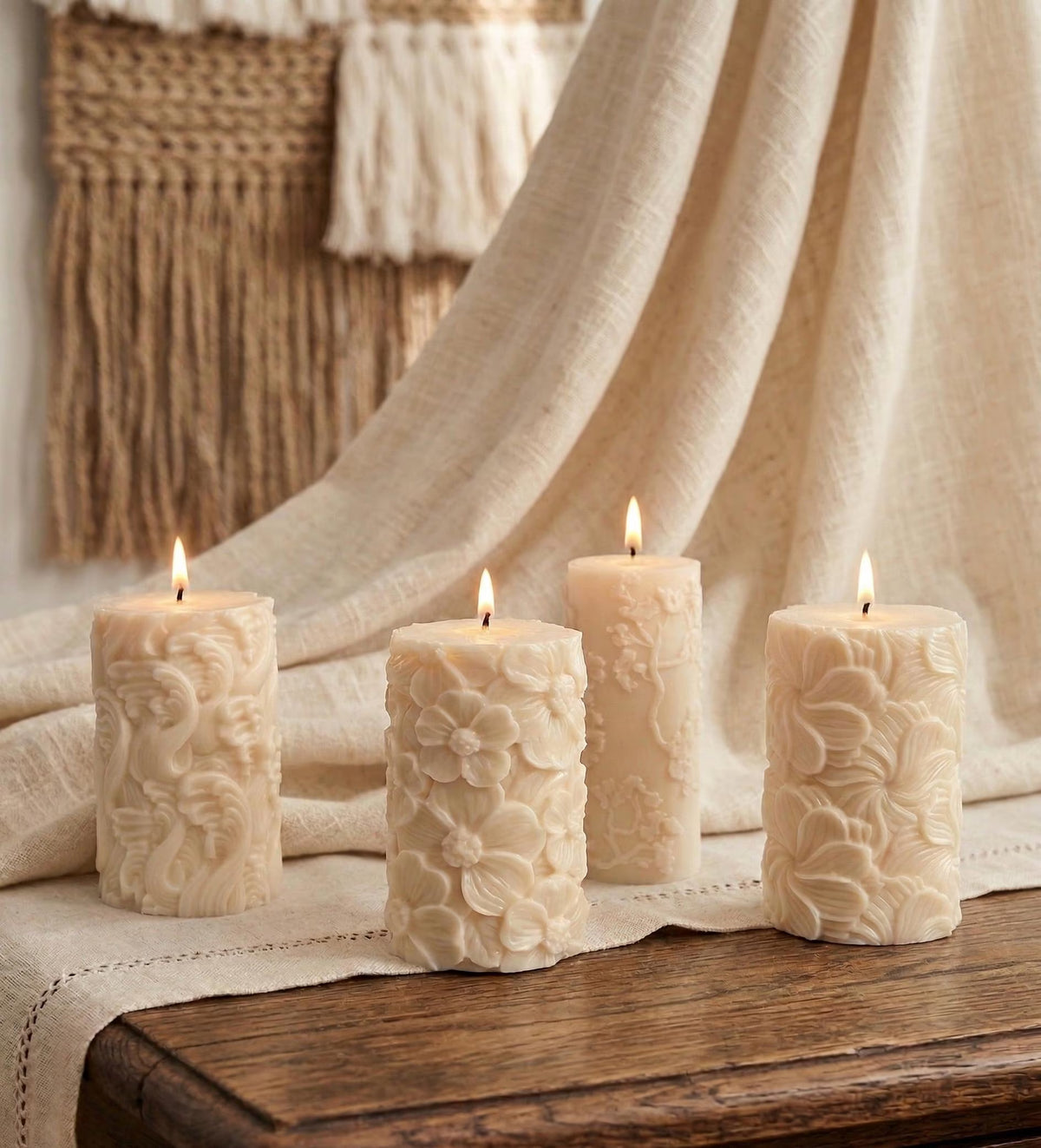 Four textured candles on a wooden surface with a neutral background